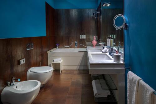 a bathroom with a toilet and a sink and a tub at Hotel Number Nine in Florence
