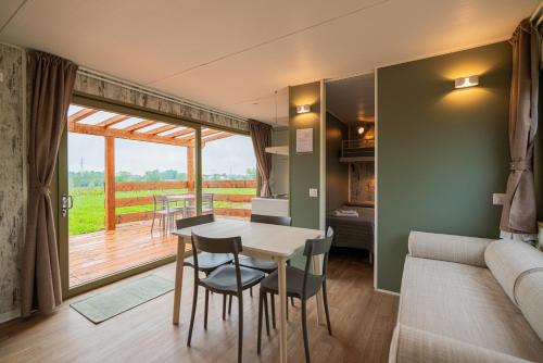 a living room with a table and chairs and a couch at Agriturismo dei Grippi in Sona