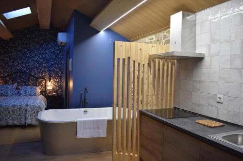 a bathroom with a tub and a bed and a sink at Cabana de Pili in A Estrada