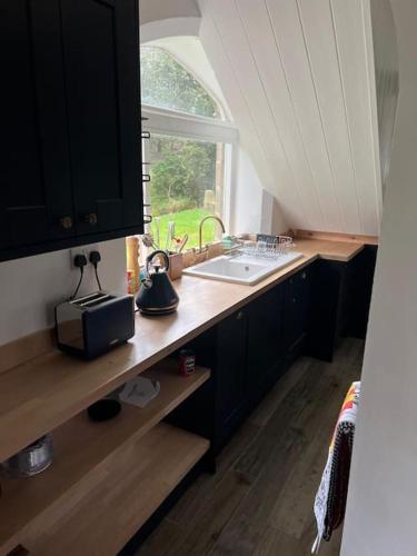a kitchen with a sink and a window at East Lodge - Chillingham Castle in Alnwick