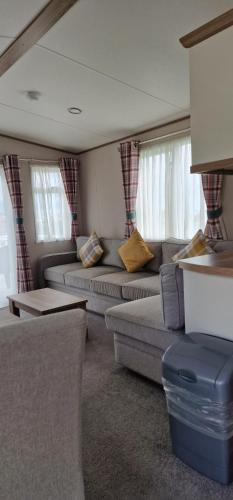 a living room with two couches and a table at Bay View in Paignton