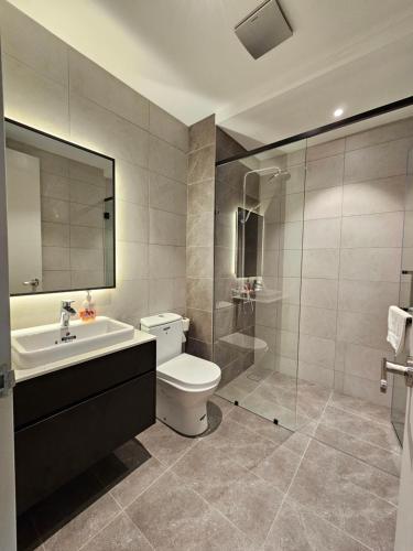 a bathroom with a toilet and a sink and a shower at Maxx Royal Suites at Axon Kuala Lumpur in Kuala Lumpur