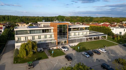 an aerial view of a building with cars parked in a parking lot at Hotel Ponteo - Activity Park in Bratislava