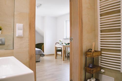 a room with a hallway with a table and a door at Apartamenty Agroturystyczne Papiernia in Niedźwiedź