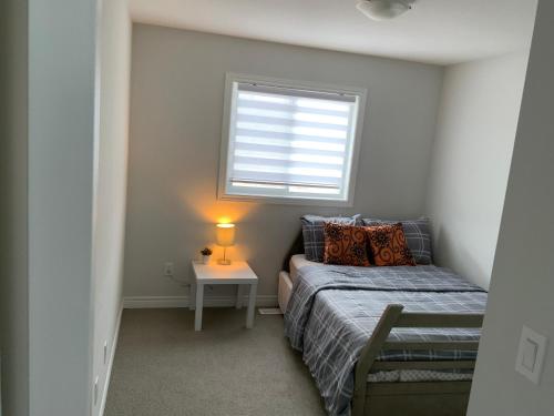a small bedroom with a bed and a window at Enchanted escape in Welland