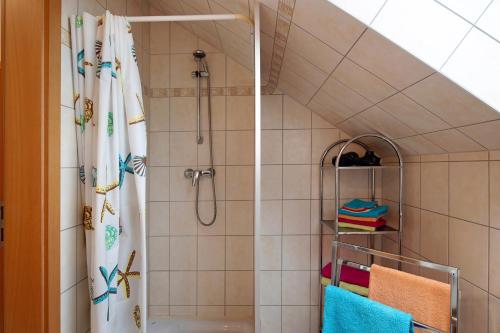 a bathroom with a shower with a shower curtain at Ferienwohnung Küstenstübchen Gruse in Bartenshagen-Parkentin