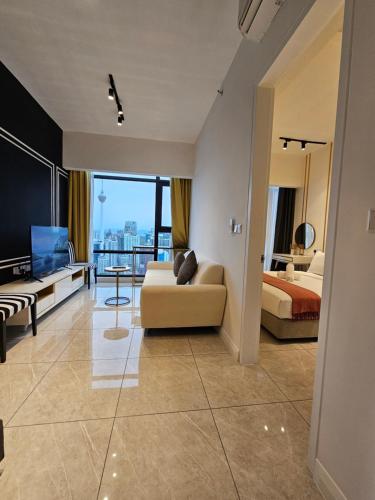 a living room with a couch and a bed at Maxx Royal Suites at Axon Kuala Lumpur in Kuala Lumpur