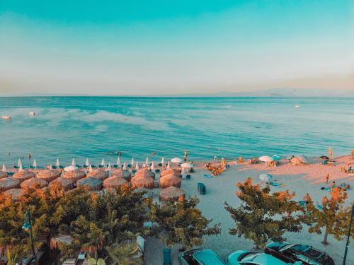 an aerial view of a beach with umbrellas and the water at Serenity Seafront garden villa in Pefkohori