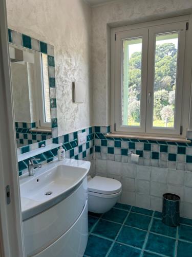 a bathroom with a sink and a toilet at Villa Colle dei Pini in Cupra Marittima
