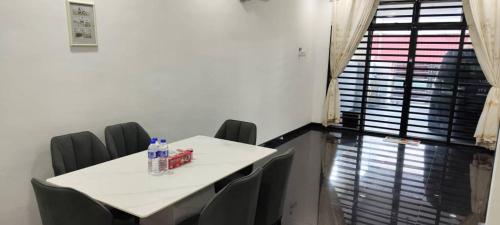 a meeting room with a white table and chairs at ankang in Alor Setar