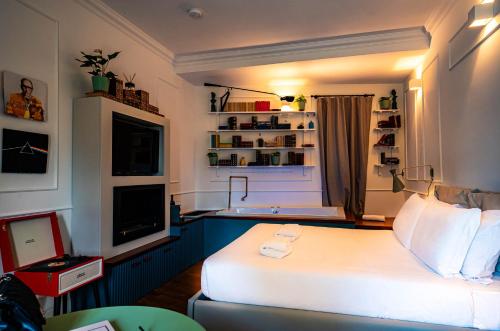 a bedroom with a white bed and a television at Giardini Penelope Resort e Spa in Ciampino