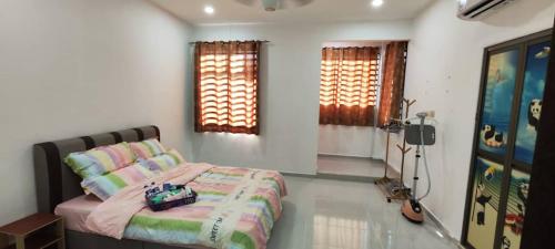 a bedroom with a bed in a room with windows at ankang in Alor Setar