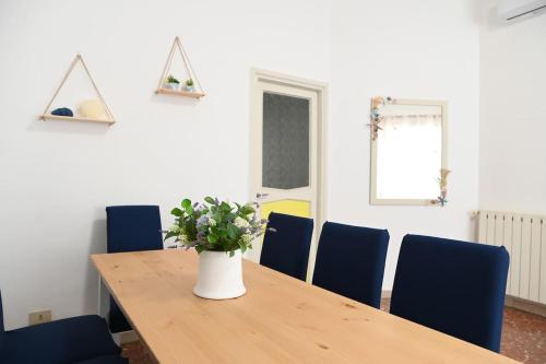 a conference room with a wooden table and blue chairs at The sea view at the port of Anzio in Anzio