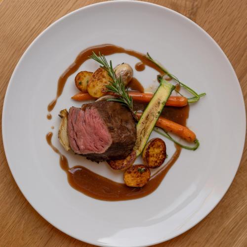 a plate of food with meat and vegetables on a table at Mallaun Hotel.Erlebnis in See