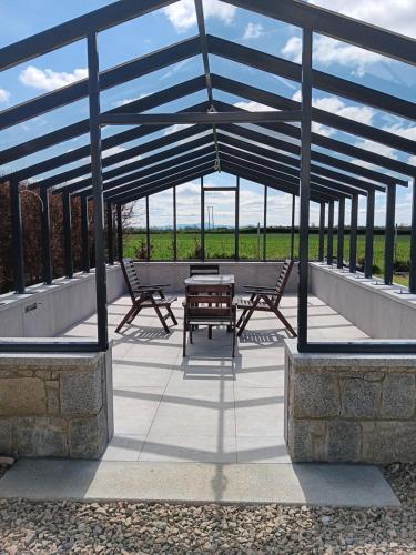 a patio with two chairs and a table in a pavilion at Duplex/2 Bedrooms on Kildare/Carlow/Laois Border in Carlow