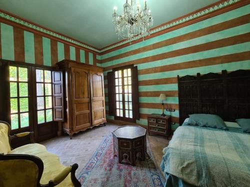 a bedroom with a large bed and striped walls at Andalusische Villa in Mairena del Aljarafe
