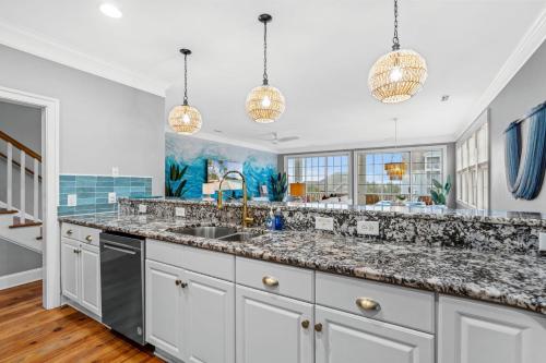 a kitchen with a sink and a counter top at Luxury Beach House Ocean AND Inlet Views in Myrtle Beach