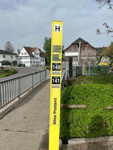 a yellow thermometer sitting on the side of a road at Small attic apartment close to Lake and Mountains Fussach in Fußach