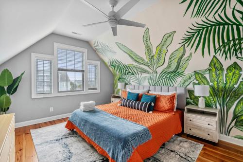 a bedroom with a mural of plants on the wall at Luxury Beach House Ocean AND Inlet Views in Myrtle Beach