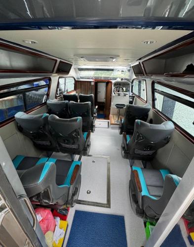 an inside view of a van with chairs and tables at DAV Travels in Labuan Bajo