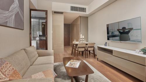 a living room with a couch and a table at Oakwood Makati Avenue in Manila