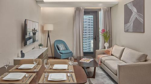 a living room with a couch and a table at Oakwood Makati Avenue in Manila