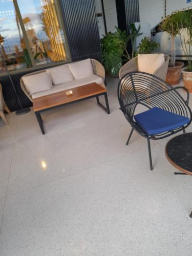 a patio with a couch and a table and a chair at Business Accommodation 'Urban Living' Intimate in Geel