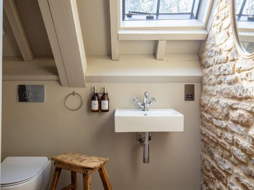 a bathroom with a sink and a toilet at The Barns at Stoneythorpe in Southam