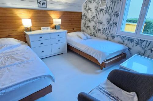 a small bedroom with two beds and a couch at Maison Bretagne in Saint-Jacut-de-la-Mer