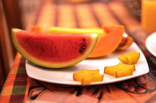 a plate with watermelon and cheese on a table at B&B Shenal Villa Kosgoda in Kosgoda
