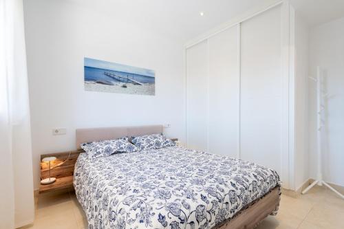 a bedroom with a bed and a painting on the wall at The Tower Villa in El Toro