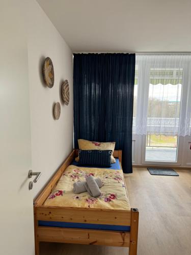 a bedroom with a bed in a room with a window at City-See Central Apartment in Marl