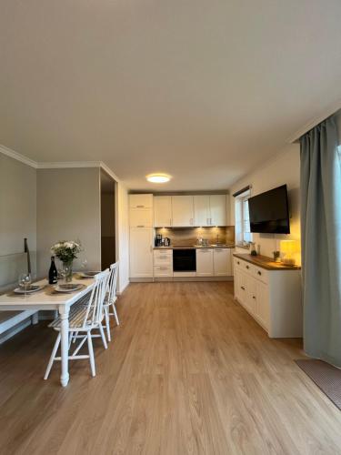 a living room with a table and a kitchen at NEU 2024 - Fewo mit Meerblick & Flair in Harrislee