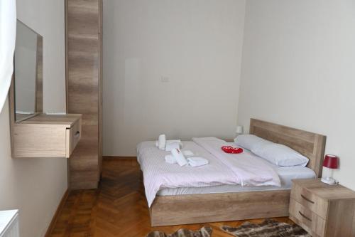 a bedroom with a bed with two towels on it at JERUSALEM luks מלון Kutaisi in Kutaisi