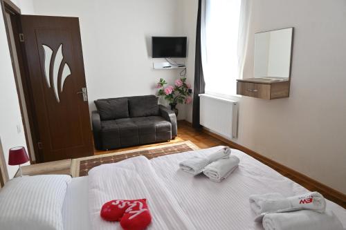 a bedroom with a bed with two towels on it at JERUSALEM luks מלון Kutaisi in Kutaisi