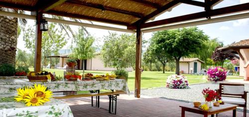 a patio with a table with flowers on it at Agriturismo Bocci in Castiglione della Pescaia