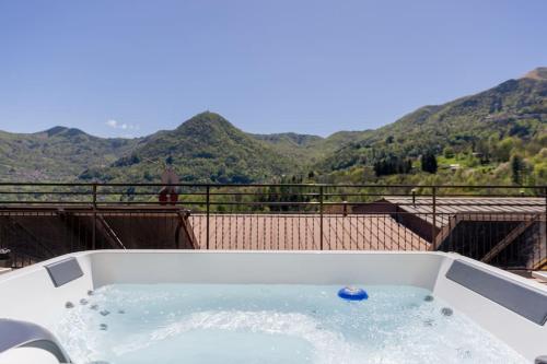 a jacuzzi tub with a view of mountains at La Terrazza sui Monti in Castiglione dʼIntelvi