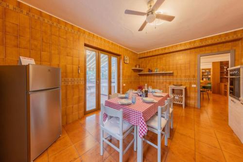 a kitchen with a table and a refrigerator at La Terrazza sui Monti in Castiglione dʼIntelvi