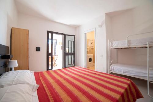a bedroom with a bed and a bunk bed at Monolocale Free Beach Residence due passi dal mare in Costa Rei