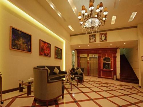 a lobby with couches and a chandelier at OYO 367 Eureka Hotel in Dubai