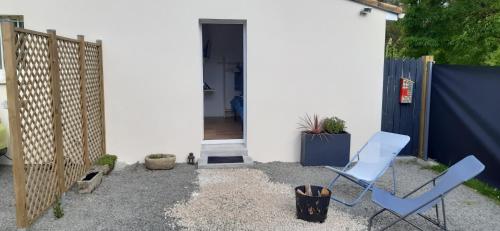 a patio with two chairs and a fence at Virginie & Yann in Saint-Léger-les-Vignes