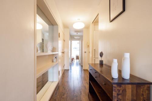 a hallway of a home with a wooden dresser at The Clerkenwell Collection in London