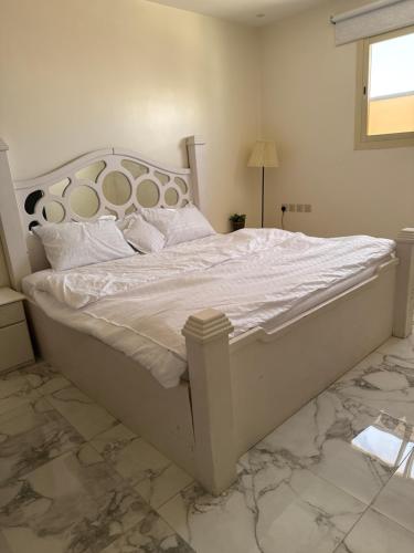 a bedroom with a large bed with white sheets and pillows at استديو in Unayzah
