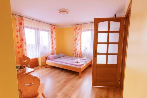 a small bedroom with a bed and a window at Willa Piękne Widoki in Ząb