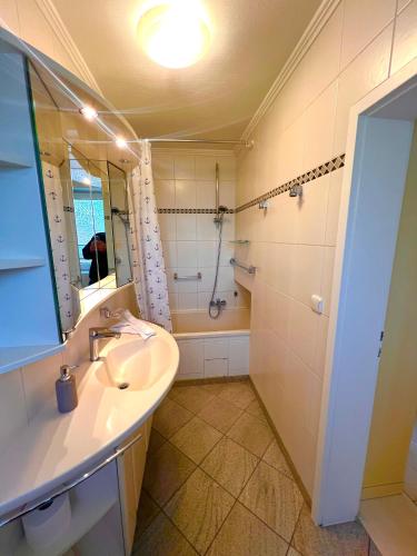 a bathroom with a sink and a shower at Ostseehaus Dreesen in Timmendorfer Strand