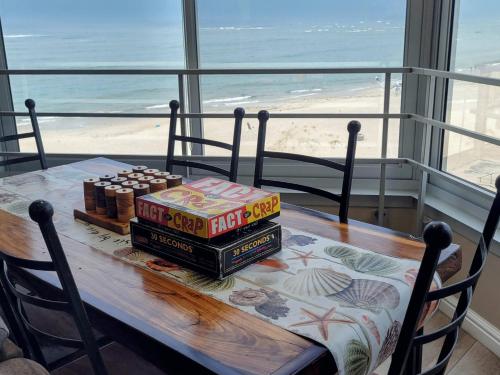 a table with two boxes of food on it with the beach at On The Beach At Strand in Strand