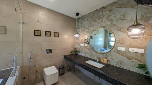 a bathroom with a sink and a mirror at Mayilveedu Guest House in Tuticorin