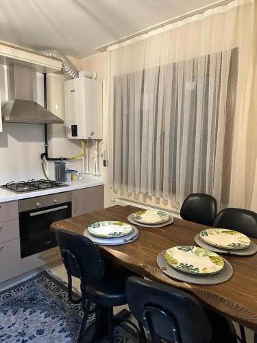 a kitchen with a wooden table with chairs around it at new flat in Muğla