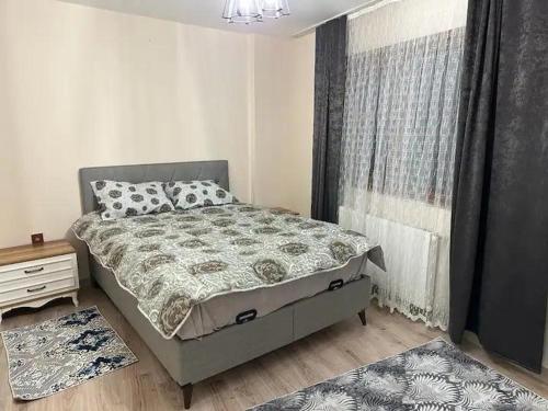 a small bedroom with a bed and a window at new flat in Mugla