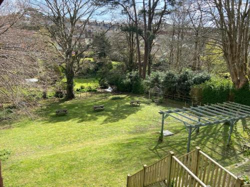 a view of a park with benches in the grass at The Regency in Ilfracombe